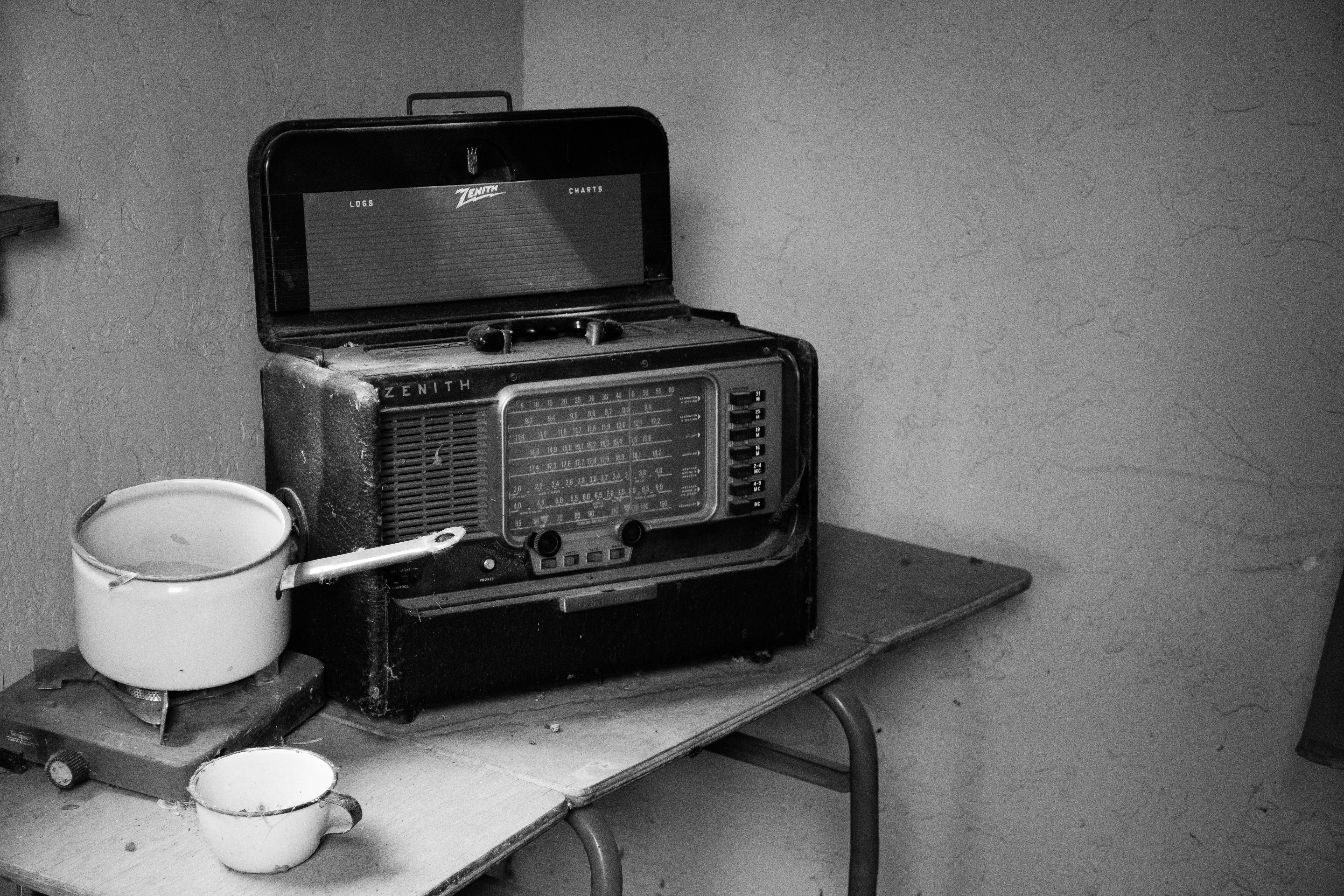 grayscale-photo-of-vintage-radio-beside-stove-with-cooking-1213922